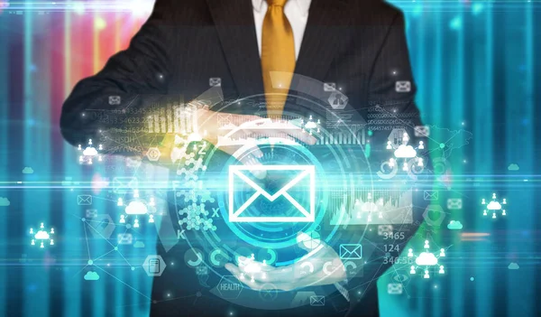 Businessman holding envelope icon in his hands with multiple technology symbols around it
