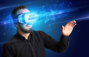 Businessman looking through Virtual Reality glasses with SOCIAL SECURITY inscription, cyber security concept clipart