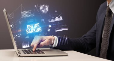 ONLINE BANING yazıtları, yeni iş konsepti ile birlikte dizüstü bilgisayarda çalışan işadamı