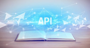 Open book with API abbreviation, modern technology concept
