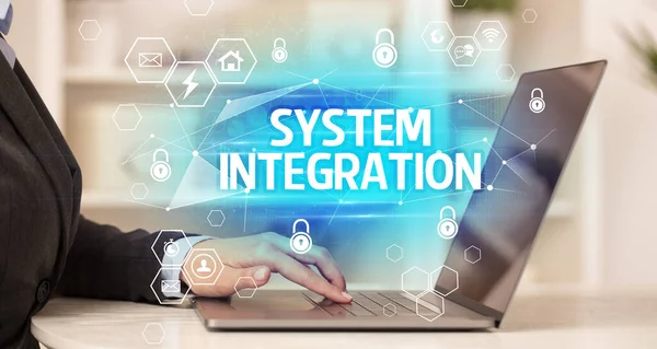 SYSTEM INTEGRATION inscription on laptop, internet security and data protection concept, blockchain and cybersecurity