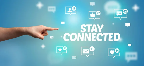 Close-Up of cropped hand pointing at STAY CONNECTED inscription, social networking concept