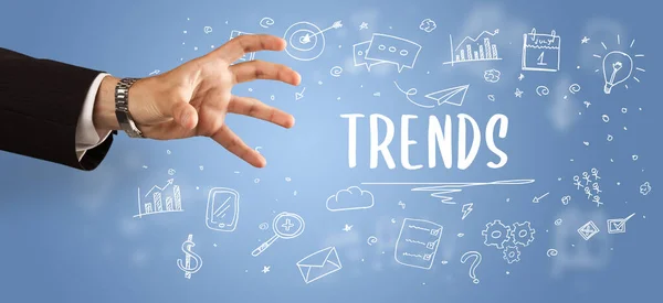 Close-Up of cropped hand pointing at TRENDS inscription, modern business solution concept