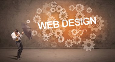WeB DESIGN yazıtları ve teknoloji kavramından şemsiyeyle savunma yapan iş adamı