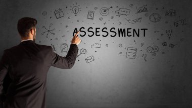 İş adamı, ASSESSMENT yazıtları ve iş stratejisi konseptiyle yaratıcı bir fikir çizimi yapıyor.