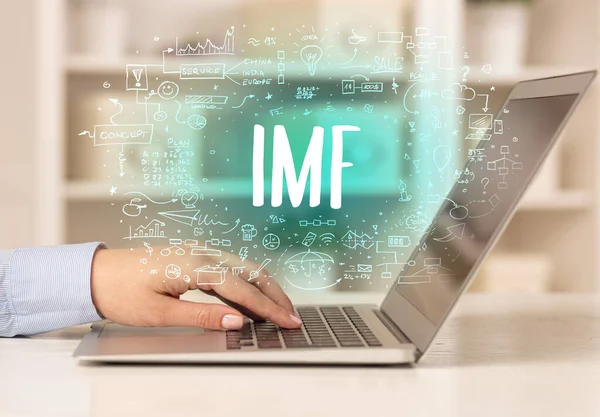 stock image hand working on new modern computer with IMF abbreviation, modern technology concept