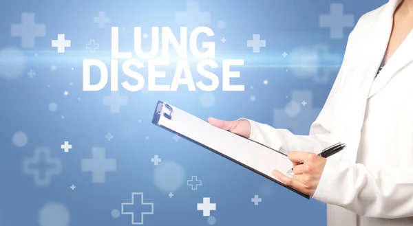 stock image doctor writes notes on the clipboard with LUNG DISEASE inscription, first aid concept