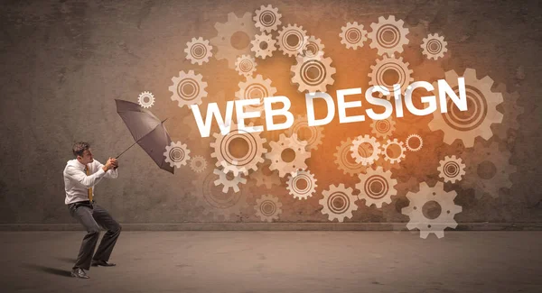 WeB DESIGN yazıtları ve teknoloji kavramından şemsiyeyle savunma yapan iş adamı