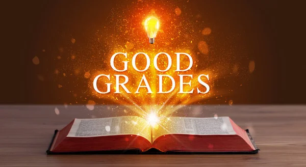 GOOD GRADES inscription coming out from an open book, educational concept