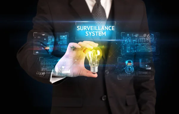 Businessman Holding Lightbulb Surveillance System Inscription Online Security Idea Concept — Stock Photo, Image