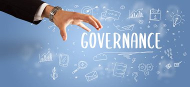 GOVERNANCE yazıtına işaret eden kırpılmış elin yakın çekimi, modern iş çözümleri kavramı