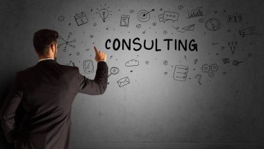 businessman drawing a creative idea sketch with CONSULTING inscription, business strategy concept