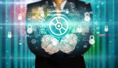 İş adamı elinde disk simgesi ve etrafında birden fazla teknoloji sembolü tutuyor.