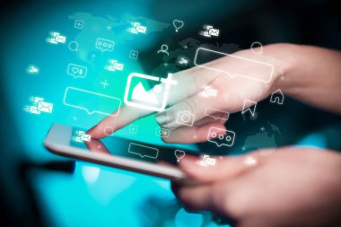 Tablet kullanan ve içinden fotoğraf simgeleri çıkan bir elin yakın plan görüntüsü, sosyal medya kavramı