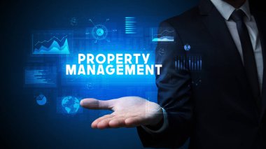 Mülkiyet Yönetimi yazıtlarını tutan İşadamı 'nın eli, iş başarısı kavramı