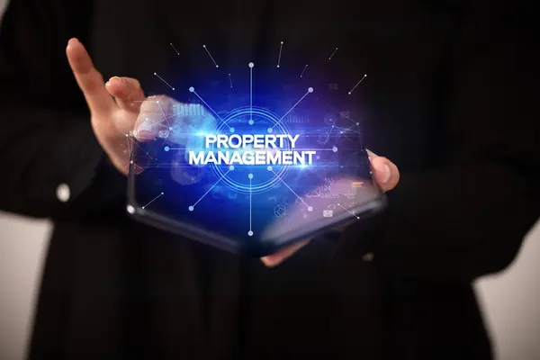 Businessman Holding Foldable Smartphone Property Management Inscription New Business Concept — Stock Photo, Image