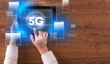 5G kısaltmalı el ele tutuşma tabletinin yakın çekimi, modern teknoloji kavramı