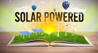 Open book with SOLAR POWERED inscription, renewable energy concept