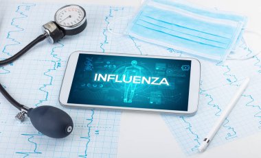 INFLUENZA yazıtlı tablet pc ve doktor araçları, koronavirüs kavramı