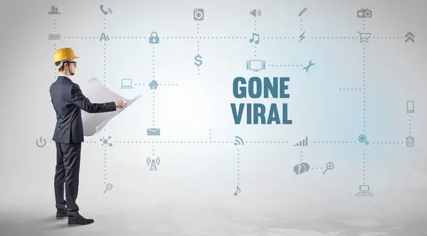 Engineer working on a new social media platform with GONE VIRAL inscription concept
