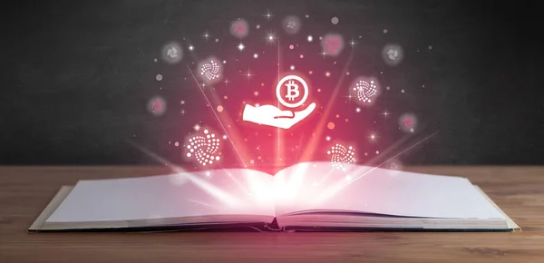 Open book with giving bitcoin icons above, currency exchange concept