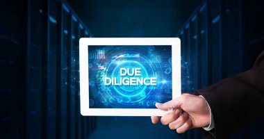 Tablet üzerinde çalışan genç iş adamı ve yazıyı gösteriyor: DUE DILIGENCE, business concept