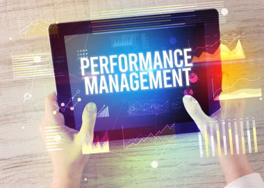 Performans Yönetimi yazılı tableti, modern iş konsepti olan ellerin yakın çekimi