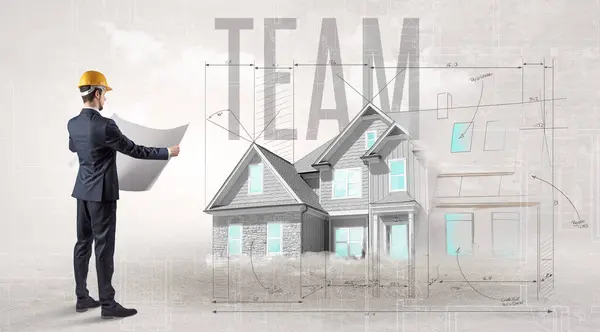 Young Engineer Holding Blueprint Team Inscription House Planning Concept — Stock Photo, Image