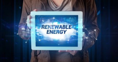 Tablet üzerinde çalışan genç iş adamı ve yazıyı gösteriyor: Yenilenebilir Enerji