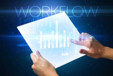 Üzerinde WorKFLOW yazıtı olan fütüristik tablet, modern iş kavramı.