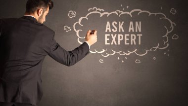 İş adamı, içinde Ask An Expert yazıtı olan bir bulut çiziyor, modern iş konsepti.