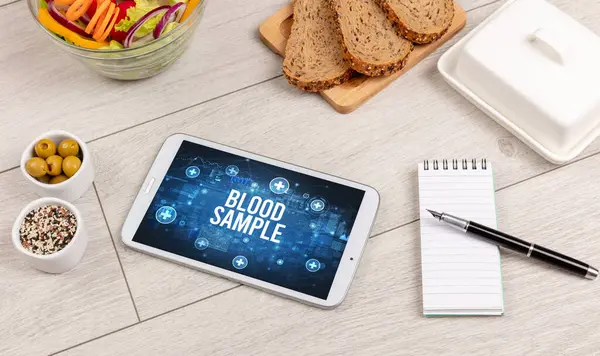 stock image BLOOD SAMPLE concept in tablet pc with healthy food around, top view concept