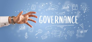 GOVERNANCE yazıtına işaret eden kırpılmış elin yakın çekimi, modern iş çözümleri kavramı