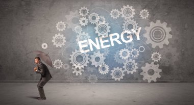 ENERGY yazıtları ve teknoloji kavramından şemsiyeyle savunma yapan iş adamı
