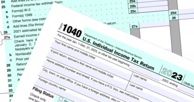 Tax form 1040 USA Individual Income Tax Return, close-up view and slow rotation over IRS application form, tax accounting document, footage