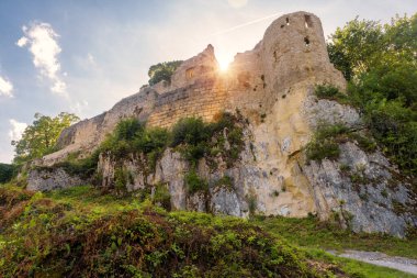 Hohenurach Castle near old town of Bad Urach, Germany. Scenery of abandoned German castle on mountain top and sun in Swabian Alps. Theme of travel, tourism and sightseeing in Baden-Wurttemberg.