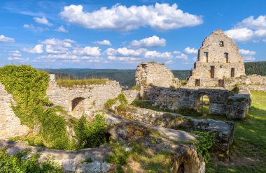 Hohenurach Castle on mountain top, Bad Urach, Germany. Scenic view of old stone house ruins overgrown by ivy. Scenery of German castle, tourist attraction of Swabian Alps in summer. Travel theme.