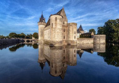 Castle chateau de Sully-sur-Loire, France. It is landmark of Loire Valley. Scenic view of French medieval castle like fortress, landscape with old monument in middle of river. Travel in France theme.
