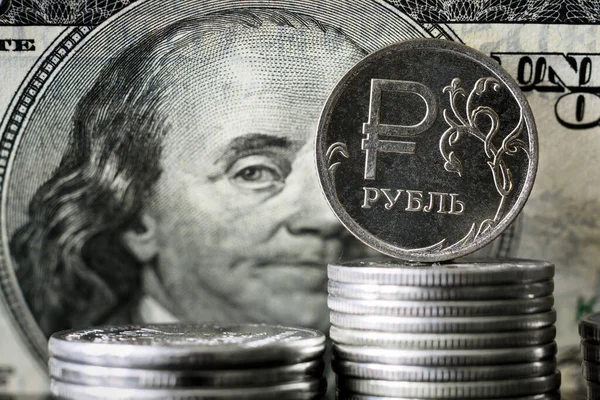 stock image Ruble coin on background of USA dollar bill, Russian ruble money is under sanctions. Concept of economy crisis, finance of Russia, currency exchange rate, inflation, politics and ruble payment.