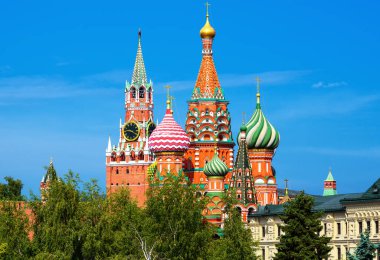 Moscow Kremlin and St Basil's cathedral in summer, Russia. Scenic view of beautiful buildings, trees and blue sky. Scenery of nice top Moscow landmarks. Concept of travel and tourism in Russia.