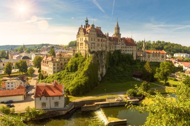 Sigmaringen city in Baden-Wurttemberg, Germany. Scenic sunny view of old German castle on rock top, landmark of Schwarzwald. Nice panorama of Swabian town at Danube River in summer. Travel theme.