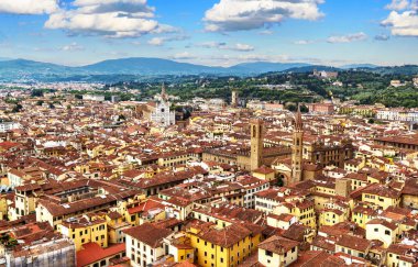 Florence view from Duomo top, Italy, Europe. Landscape of old city in Tuscany, scenery of Florence houses in summer. Florence skyline with blue sky. Theme of travel, tourism, destination and nature.
