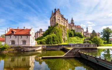 Water sluice in Sigmaringen city, Baden-Wurttemberg, Germany. Scenic view of old German castle over floodgate on Danube River in summer. Theme of nature, town, tourism and travel in Schwarzwald.