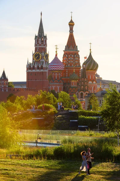 stock image Moscow - Jun 28, 2022: People walk in Zaryadye Park, Moscow, Russia. This place is tourist attraction of city. Moscow Kremlin and St Basil`s Cathedral in distance. Nature, travel and summer theme. 