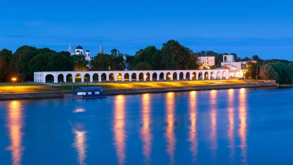 stock image Yaroslav`s Court at Volkhov River in Veliky Novgorod or Novgorod the Great, Russia. Panorama of medieval ruins at night, landmark of Novgorod. Theme of travel and sightseeing in Novgorod city.