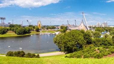 Olympic Park, Münih, Almanya 'nın simgesi. Eski spor alanının manzarası, göl manzarası, gökyüzü ve çadırlar. Yaz aylarında Münih 'te turizm, seyahat ve gezi teması.