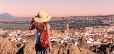 back view of woman looking at Guadix city landscape