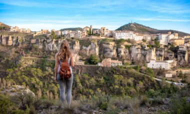 Woman tourist looking at Cuenca (Spain), casas colgadas