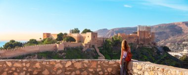 Woman tourist enjoying panorama view of Alcazaba,  Almeria in Spain
