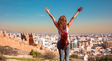 Happy tourist lookinat at panoramic view of Almeria city and Alcazaba- Spain